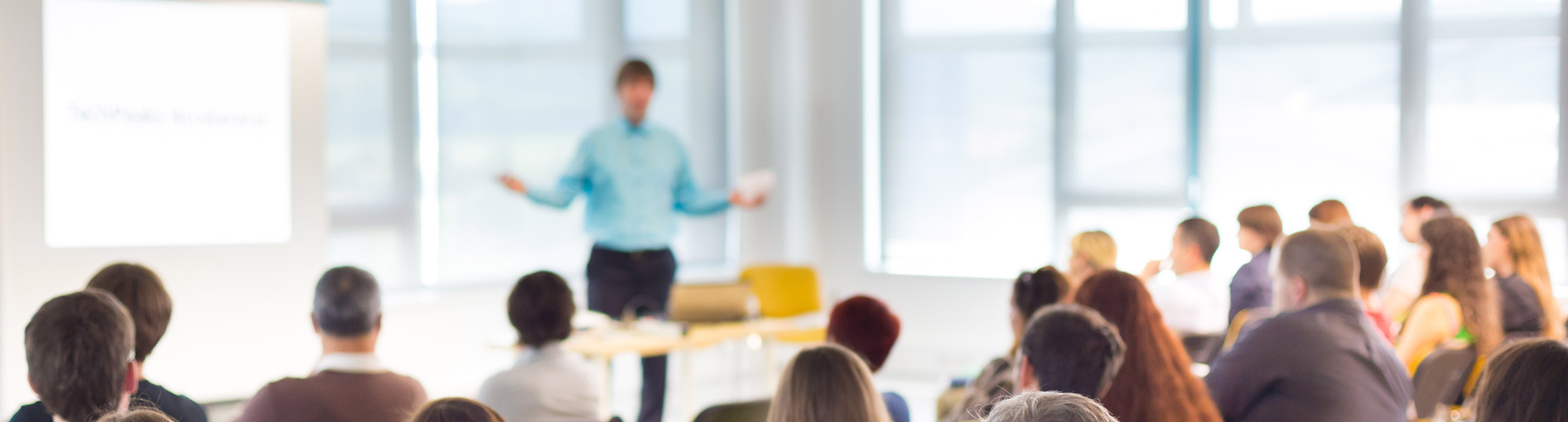 An employee presents with confidence in front of the audience after completing the training.